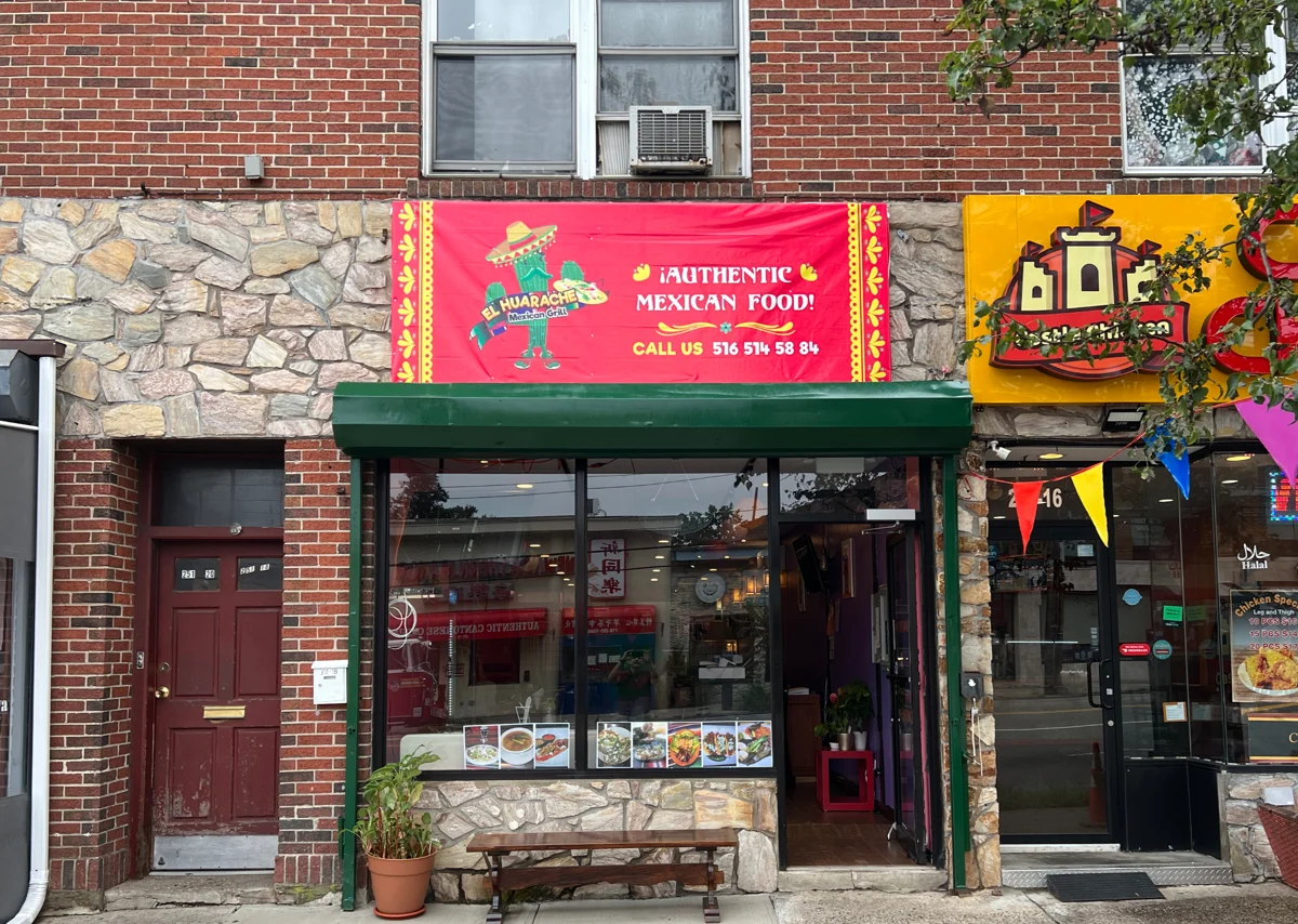 El Huarache Mexican Grill’s Little Neck storefront with pink signage and a green awning